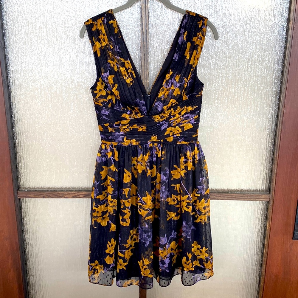 Dress the Population minidress in black with a pretty gold/periwinkle print. XS